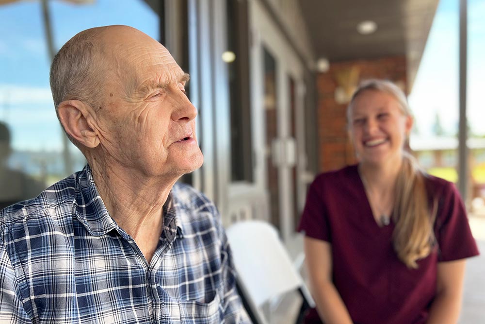 Country Care working with older man care resident laughing